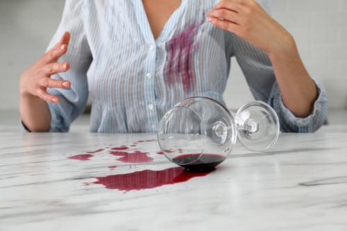 woman spills wine on shirt