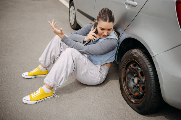 distressed woman with a flat tire