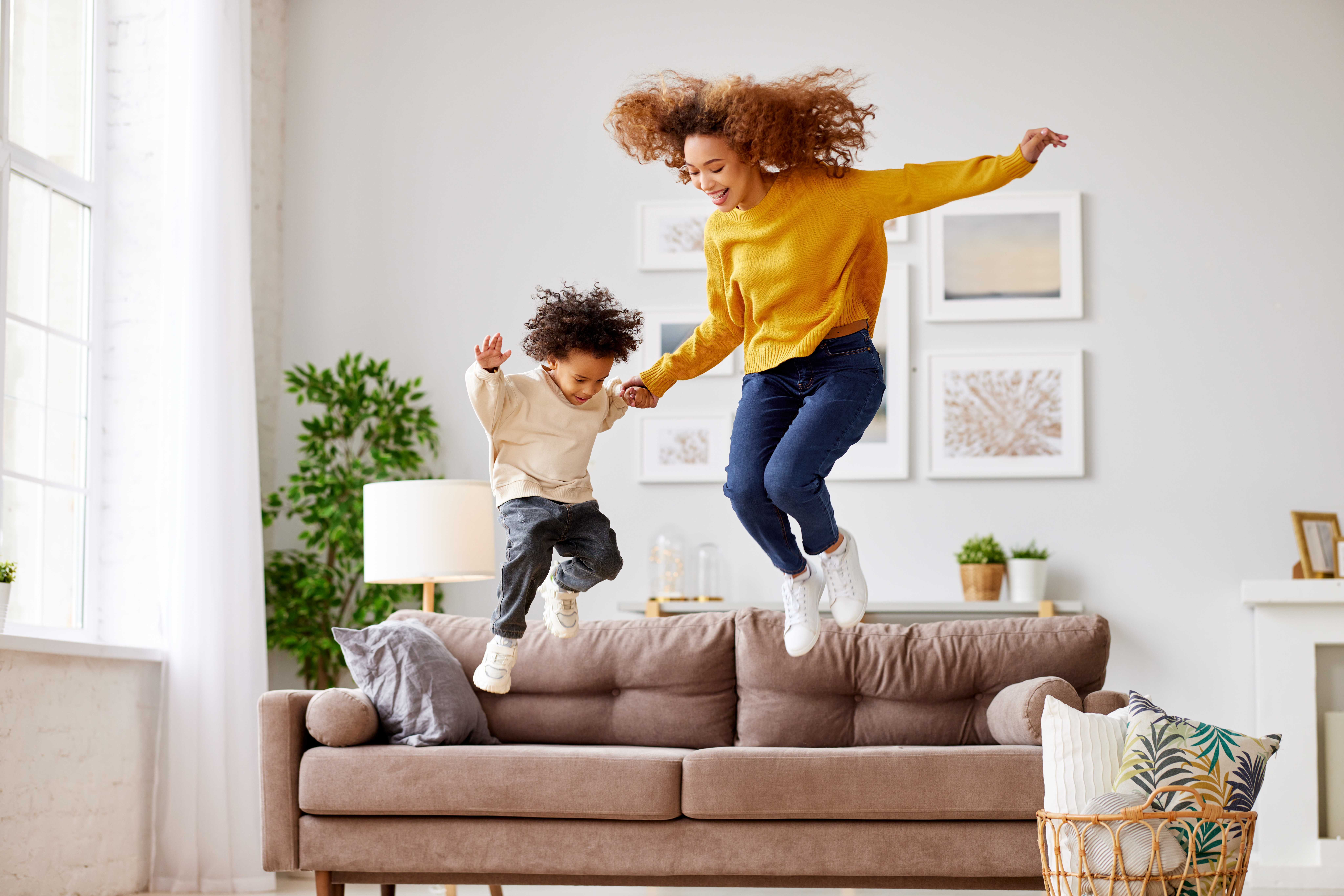 two people jumping on a couch